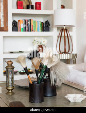 Paintbrushes on coffee table Stock Photo