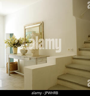 Gustavian style hall table and decor next to staircase Stock Photo