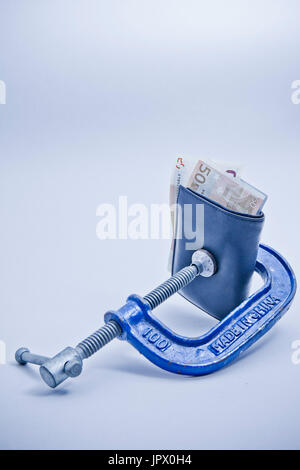 wallet squeezed in a clamp Stock Photo