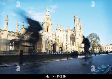 Rush hour in Cambridge, as cyclists, blurred cycling past Kings College Cambridge on a sunny day with blue sky Stock Photo