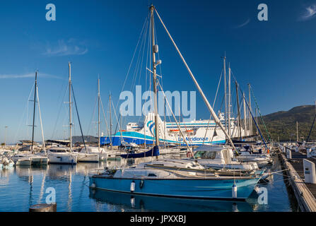Sailboats at marina, M/F Kalliste ferry at pier behind, at Golfe de Valinco, Propriano, Corse-du-Sud, Corsica, France Stock Photo