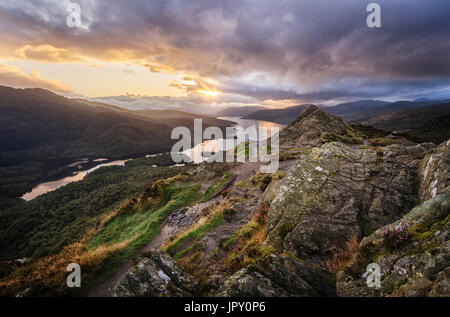 Dramatic Sunset Sky over Loch Katrine in the Trossachs in Scotland from the rocky summit of Ben A'an  a popular small mountain or hill