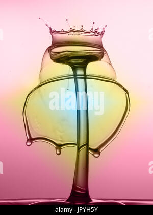Crowned Worthington spike with bell shape formed over the top against a pink and yellow background making an interesting combination of coloured forms Stock Photo