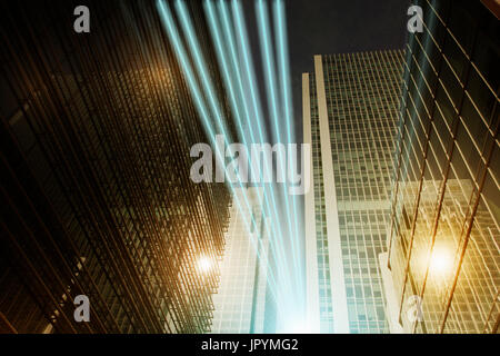 Fiber optic light trail communication technology streaming through highrise buildings, concept Stock Photo