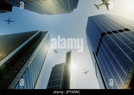 Airplanes flying over highrise buildings, travel concept Stock Photo