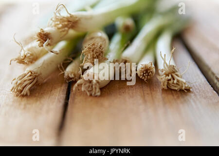 Still life close up fresh, organic, healthy, green onions and roots wood Stock Photo