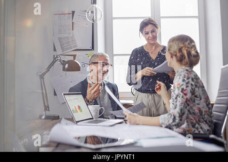 Business people planning, discussing paperwork in office meeting Stock Photo