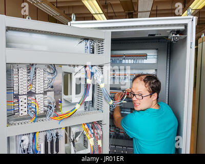 Electrical engineer configuring wires. Stock Photo