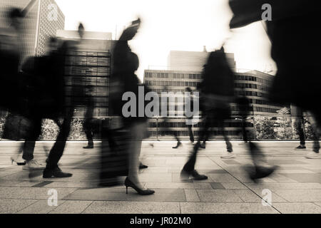 Business and office workers going to work in a fast blur during morning rush hour in Tokyo, Japan