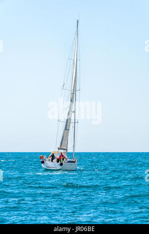 Sailing ship yachts with white sails in the open Sea. Luxury boats. Stock Photo