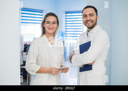 Two doctors discussing diagnosis while walking Stock Photo
