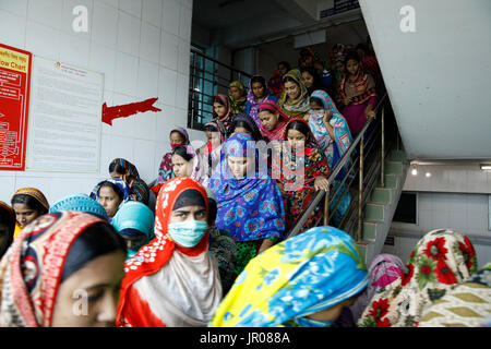 Garment workers go out for having lunch in a factory in Gazipur, Bangladesh on April 19, 2015. Stock Photo