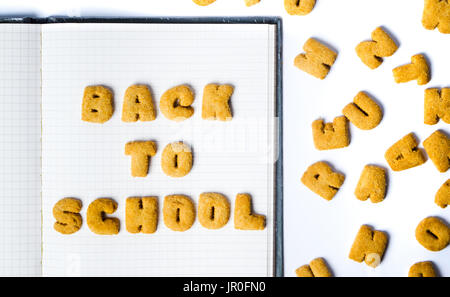 Back to school written with cookies on a notebook Stock Photo