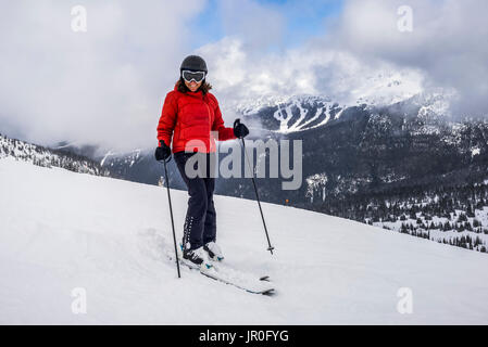 A Female Downhill Skier Poses For The Camera On A Ski Hill At A Ski Resort; Whistler, British Columbia, Canada Stock Photo