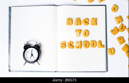 Back to school written with cookies on a notebook Stock Photo