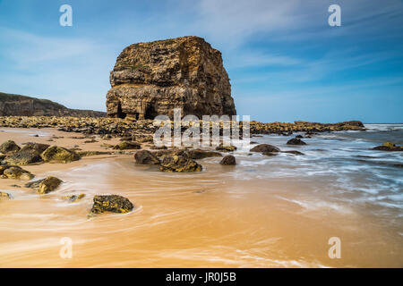 Large Sea Stack On Sandy Beach On The North East Coast Of England; South Shields, Tyne And Wear, England Stock Photo