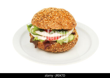 Chicken and salad in a brown seeded bread roll on a plate isolated against white Stock Photo