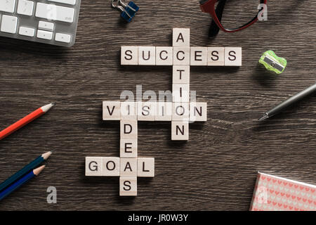 Success achieving business keywords collected of wooden cubes in crossword Stock Photo