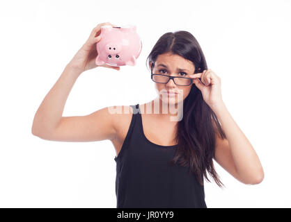 Young woman worried with a piggy bank Stock Photo