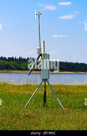 A weather monitoring station beside a river. Stock Photo