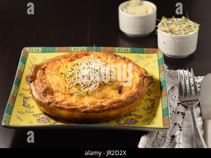Vegetarian cheese quiche ready for meal with sides Stock Photo