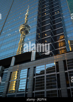 Low Angle View Of The Cn Tower Reflected In The Glass Facade Of An Office Building; Toronto, Ontario, Canada Stock Photo