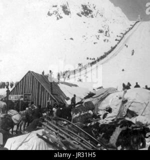 Bound for the Klondike Gold Fields, Chilcoot Pass, Alaska. The Klondike Gold Rush was a migration by an estimated 100,000 prospectors to the Klondike region of the Yukon between 1896-99. Gold was discovered by local miners on August 16, 1896 and, when news reached Seattle and San Francisco, it triggered a stampede of would-be prospectors. To reach the gold fields most took the route through the ports of Dyea and Skagway in Alaska. Here, the Klondikers could follow either the Chilkoot or the White Pass trails to the Yukon River and sail down to the Klondike. Each of them was required to bring a Stock Photo