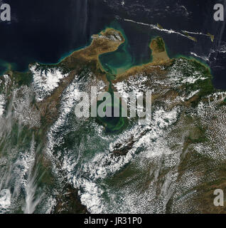 Lake Maracaibo, Venezuela, with swirls of green plant life, captured by the Moderate Resolution Imaging Spectroradiometer (MODIS) on NASA's Aqua satellite in February 2017. Heavy rain mixes the water layers in the lake, freeing up nutrients for plants to grow. The swirling currents form as water comes in from the Caribbean through the narrow strait. Stock Photo