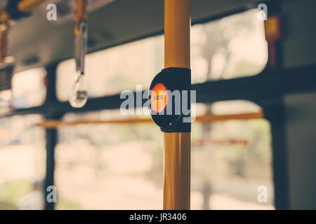 SOS button on yellow holder in modern bus Stock Photo