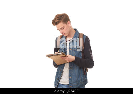 Schoolboy writing in notepad Stock Photo