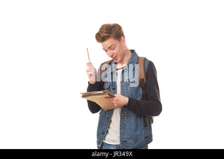 Schoolboy writing in notepad Stock Photo