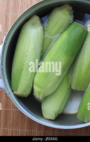 Corn in a pot ready for boiling Stock Photo