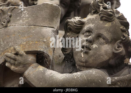 Stone statue of a young boy holding a bird bath in a country garden,  Lancashire UK. September 2018 Stock Photo - Alamy