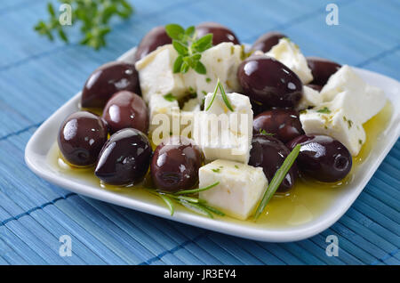 Greek Kalamata olives and feta cheese with olive oil, a mediterranean snack Stock Photo