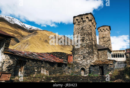 Traditional ancient Svan Towers and machub house with flagstone in Ushguli village, Upper Svaneti, Georgia. Georgian landmark Stock Photo