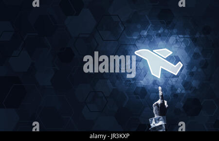 Airplane glowing icon touched with finger as online booking conc Stock Photo