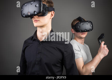 two young man playing game using virtual reality headset Stock Photo