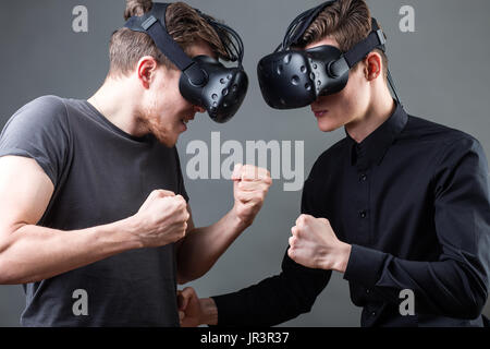Shot of two young man standing with VR goggles. Developers testing virtual reality glasses Stock Photo