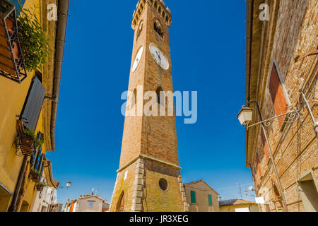 dizzy clock  tower in ancient square of medieval village in Romagna, Italy Stock Photo