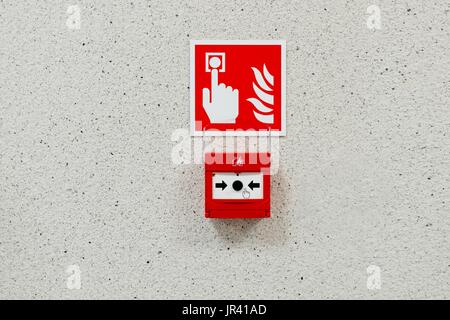 Red fire alarm button installed on the wall Stock Photo