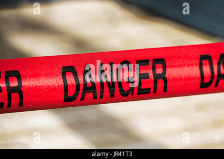 Closeup of red danger tape. Stock Photo