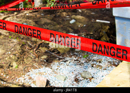 Danger tape cordoning off a concrete foundation. Stock Photo