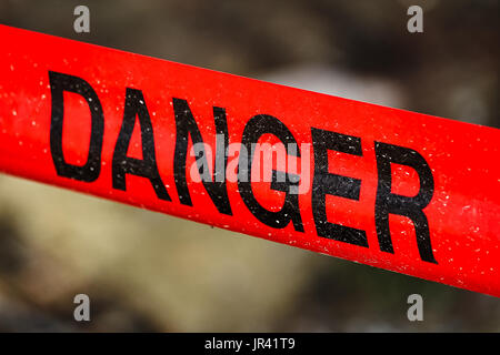 Closeup of red danger tape. Stock Photo