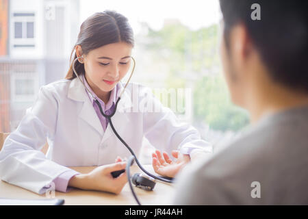 doctor using a stethoscope for examining patient, medical concept Stock Photo