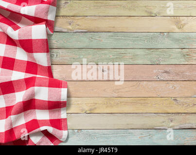 red checkered picnic tablecloth on colorful wood table Stock Photo