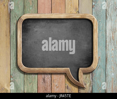 old chalkboard in shape of speech bubble on colorful wood 3d illustration Stock Photo