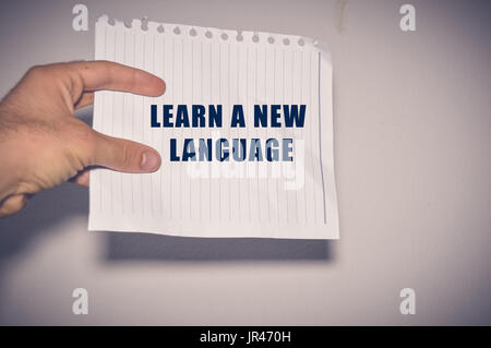 Learn A New Language written on white paper, Education Concept Stock Photo