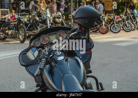 Classic motorbike at an biker meeting in Italian town. detail with vintage effect filter. Stock Photo