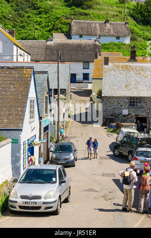 Tourists in the street in Cadgwith village, Cornwall, UK in summer Stock Photo