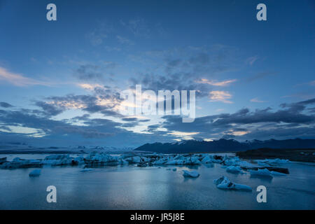 Iceland - Night over glacier lagoon joekulsarlon with many ice floes swimming Stock Photo